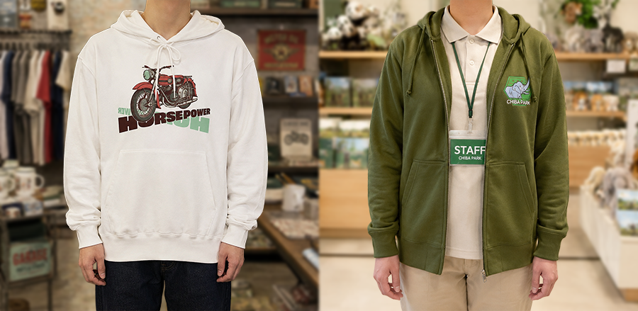 Two people stand side by side in a store: a white hoodie with a motorcycle graphic on the left and a green zip hoodie with a staff badge on the right, both casual uniforms.